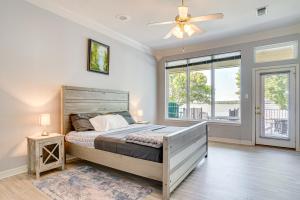 a bedroom with a bed and a ceiling fan at Luxe Lakefront Home with Hot Tub, Dock and Fire Pit in Granbury