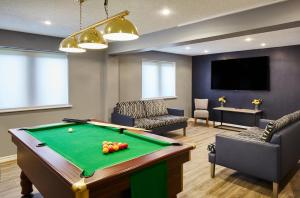 a living room with a pool table and a tv at Leonardo Inn Aberdeen Airport in Dyce