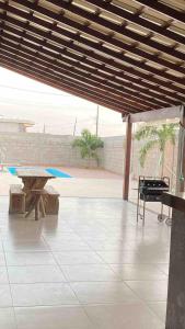 a patio with a picnic table and a piano at Vila dos ventos in Marataizes