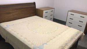 a bed in a bedroom with two dressers at Vila dos ventos in Marataizes +50 photos