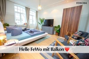 a bedroom with a bed and a living room at 12 FEWOs im Jugendstilhaus mit Aufzug, Terrasse, Kingsize-Bett, Smart-TV, etc in Erfurt