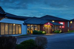 a hotel with a building with a lot of windows at Leonardo Inn Aberdeen Airport in Dyce