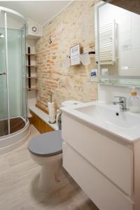 a bathroom with a toilet and a sink and a shower at Les Gîtes de La Croix Liaud in Saint-Sulpice-en-Pareds