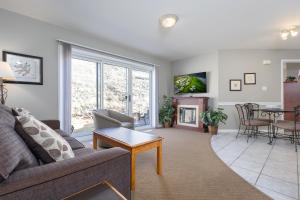 a living room with a couch and a table at Paradise Canyon Golf Resort - Luxury Condo M403 in Lethbridge