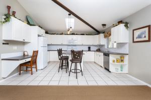 Una cocina con gabinetes blancos y una mesa y sillas. en Paradise Canyon Golf Resort - Signature Villa 380, en Lethbridge