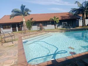a large swimming pool in front of a house at Tettey Happy Home in Durban