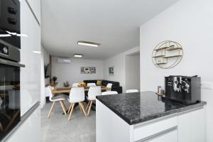 a kitchen and living room with a table and chairs at Apartmani Cicak in Vir