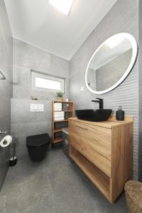 a bathroom with a sink and a mirror at Apartmani Cicak in Vir +37 photos