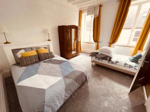 a bedroom with a bed and a crib in it at Maison Henriette in Léré +36 photos