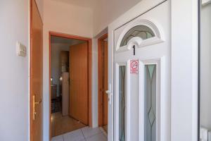 a door with a no smoking sign in a hallway at Apartments Kata in Malinska +38 photos