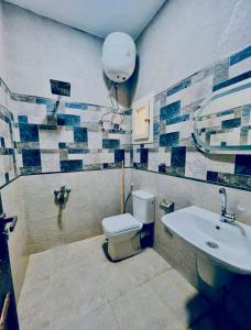 a bathroom with a toilet and a sink at Rosiland Villa - Marsa Matrouh in Marsa Matruh +9 photos