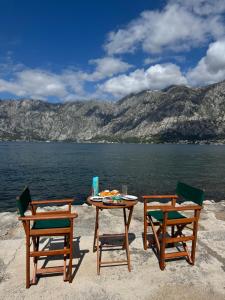 two chairs and a table and a table and two chairs at Studio 032 in Prčanj