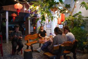 a group of people sitting around a table in a restaurant at Immersive Homestay Ninh Binh in Văn Ha