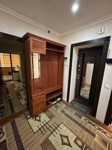 a room with a large wooden cabinet and a door at Aile Bukhara in Bukhara