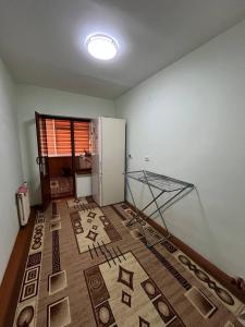 a room with a floor with a rug on it at Aile Bukhara in Bukhara