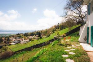 a house with a table and chairs on a hill at La Maison d'en Haut in Montézillon