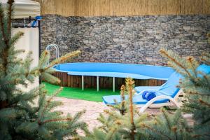 a swimming pool in a yard with a blue tub at Apartments & Villa Georg in Odesa