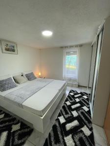 a bedroom with a large bed and a rug at Villa Dzeno Sarajevo in Krivoglavci +37 photos