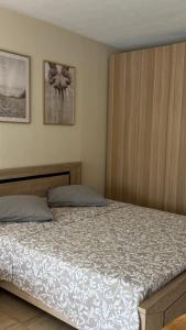 a bedroom with a bed and two pictures on the wall at Habana in Saint-Laurent-du-Var