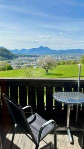 a table and a chair on a balcony with a view at Hotel Schöne Aussicht in Salzburg
