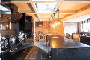 a kitchen with a large table in a room at Gibbet Windmill pet friendly home & paddock in Saughall