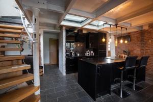 a kitchen with a black island in a room at Gibbet Windmill pet friendly home & paddock in Saughall