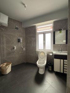 a bathroom with a toilet and a sink at Hotel Sky High in Pakyong