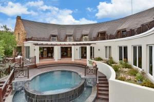 an exterior view of a house with a swimming pool at Mount Grace Hotel & Spa in Magaliesburg