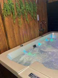 a bath tub with blue lights in it at צימר סול in Tiberias
