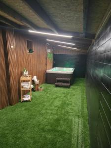 a bathroom with a tub and green grass at צימר סול in Tiberias