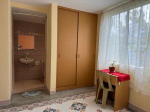 a bathroom with a sink and a toilet and a window at CasaLinda Homestay in Mambajao +19 photos