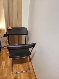 a black chair sitting next to a wall at The Golden Park in Oslo +12 photos