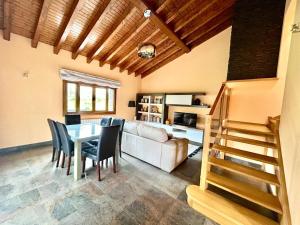 a living room with a couch and a table and chairs at Chalet Huerta de Cañamal - Llanes in Llanes