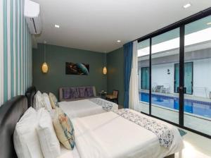 Postel nebo postele na pokoji v ubytování The COZY NATURE pool villas phuket + 5 fotografií