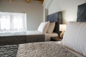a bedroom with two beds and a window at Zante way villas in Zakynthos +31 photos