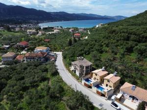 a town on a hill with a road and a lake at Zante way villas in Zakynthos