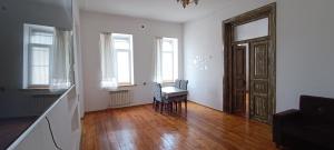 an empty living room with a chair and a door at House Ganja in Ganja