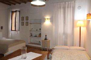 a bedroom with a bed and a table with a lamp at Lovely Home - Bike Friendly in Buonconvento