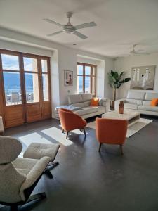 a living room with couches and chairs and a table at Villa Savoie - luxe et sérénité- piscine, sauna et jacuzzi - Annecy location prestige in Veyrier-du-Lac