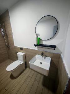 a bathroom with a sink and a mirror and a toilet at AZ Mahkota Valley Suites studio in Kuantan +18 photos