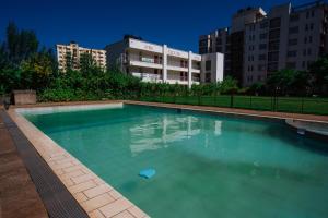 a large swimming pool in a city with buildings at Classy One Bedroom Along Ngong Road in Nairobi