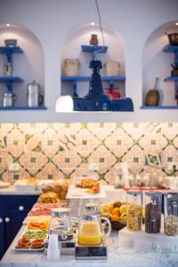 a kitchen counter with plates of food and drinks at Hotel Mignon Meublè in Sorrento