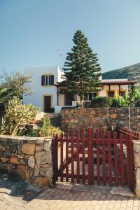 a red fence in front of a house at Villa Melivia in Hersonissos
