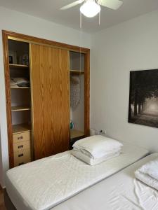 a bedroom with a bed and a wooden cabinet at Casa El Mirador in Viña de Raja +25 photos