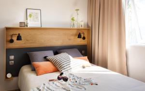 a bedroom with a bed with pillows on it at Adam Campingplatz in Bühl