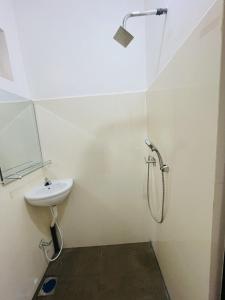 a white bathroom with a sink and a shower at Stay Lanka Guest House in Nikawatawana +4 photos