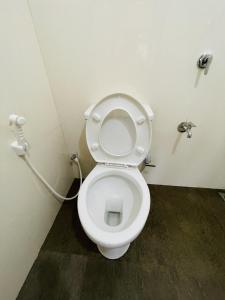 a bathroom with a white toilet in a stall at Stay Lanka Guest House in Nikawatawana