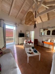 a living room with a couch and a table at Tra Vicoli e Palazzi Apartment in Tropea