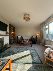 a living room with a couch and a fireplace at Firdale in Fort William