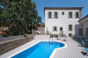 a swimming pool in front of a villa at Eressian Hotel & Hammam Spa in Eresos